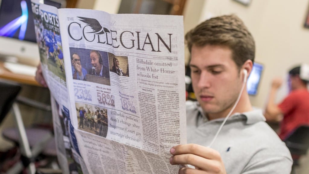 Student reading Collegian